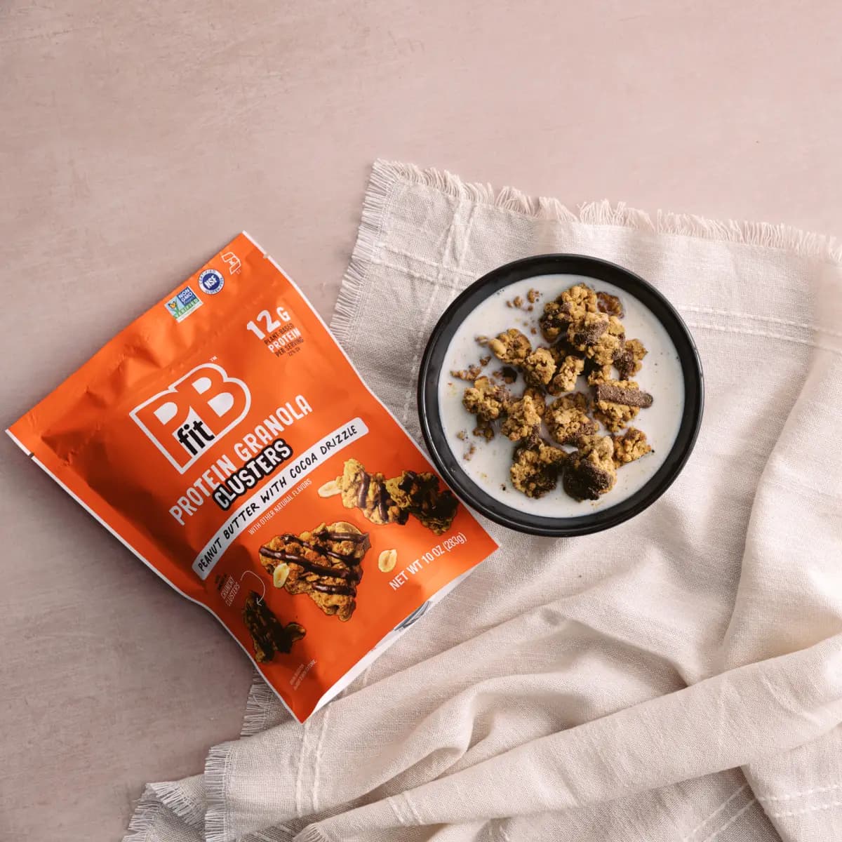 bag of clusters next to a bowl of milk and clusters