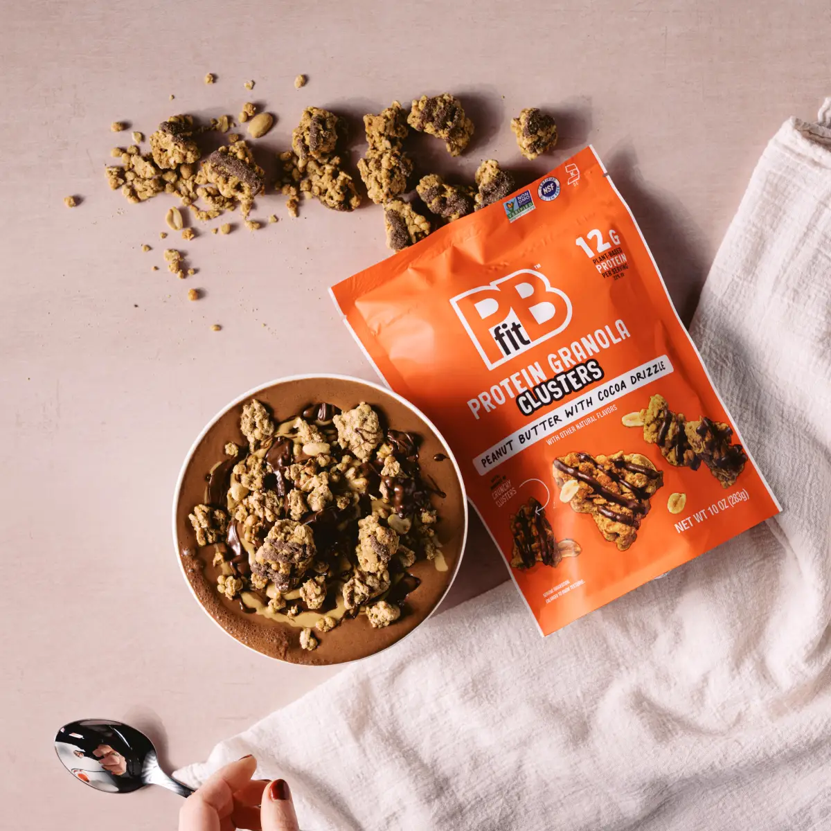 bag of clusters next to a smoothie bowl topped with clusters
