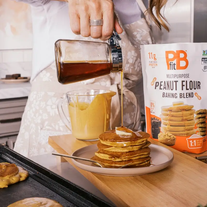 Image of someone pouring syrup on Peanut Flour Pancakes